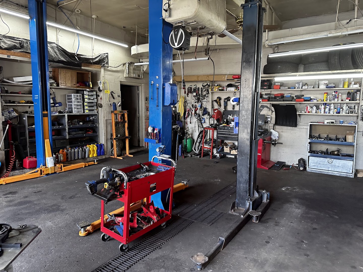Carrick auto repair shop service bays with blue hydraulic lifts and organized tool carts